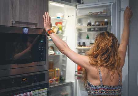 woman in front of the refrigerator.の写真素材