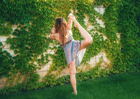 Beautiful woman practicing yoga in the garden.の写真素材