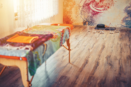 Massage table in the interior and crystal bowl. Music therapy.の写真素材