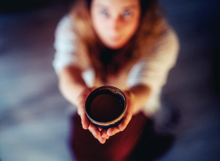 Cacao ceremony, heart opening medicine. Ceremony space. Cacao cup in womans hand.の写真素材