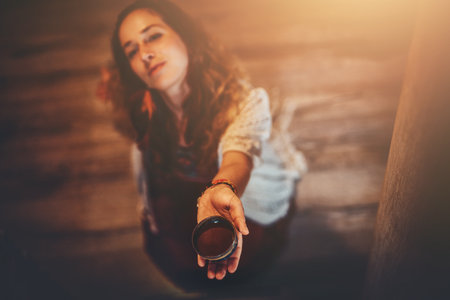 Cacao ceremony, heart opening medicine. Ceremony space. Cacao cup in womans hand.の写真素材