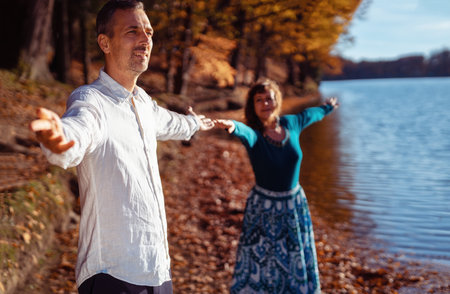 romantic couple in love by the lake in autumn.の写真素材