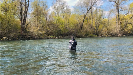 Fisherman with rod fishing on the river.