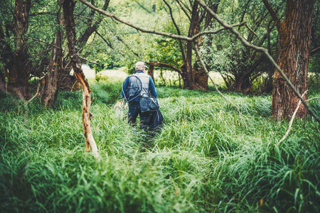 Fisherman wades through the swamp.