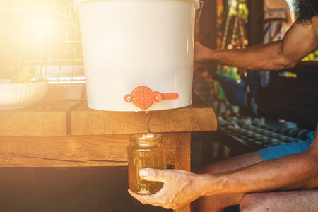 Getting honey from honeycomb. Storing honey in a bottle.