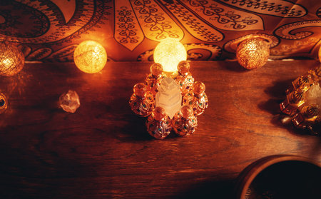 A closeup of perfumes bottles in candlelight.