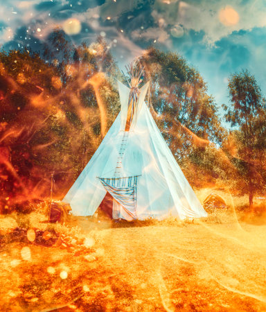 white teepee indian tent standing in beautiful summer landscape.