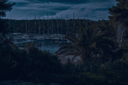 yachts and sailboat moored in a beautiful natural harbor full of greenery.の写真素材