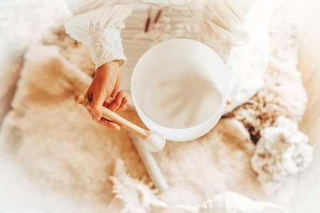 Woman playing on a crystal bowl. Ceremony space.の写真素材
