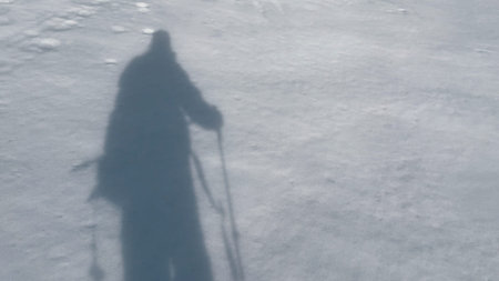 Silhouette of a tourist in high winter mountains.