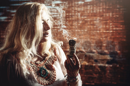 incense in a woman hand, ceremony space.の写真素材