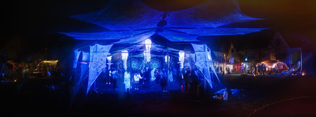 parquet with dancing people with uv lighting and stalls in the background.の写真素材