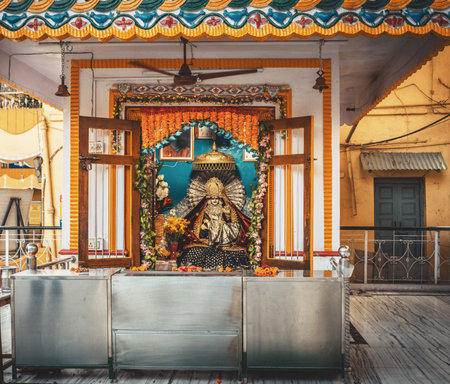 An elegantly decorated temple altar with flowers and garlands.