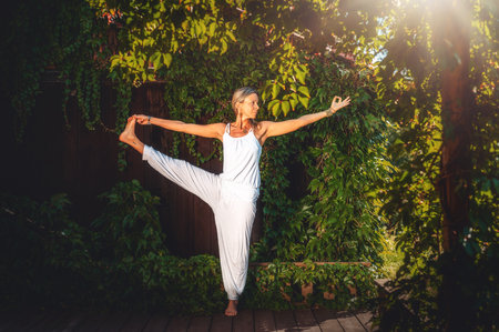 Beautiful woman practicing yoga on a terrace.の写真素材