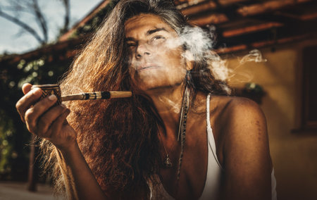 Beautiful shaman woman with pipes.の写真素材
