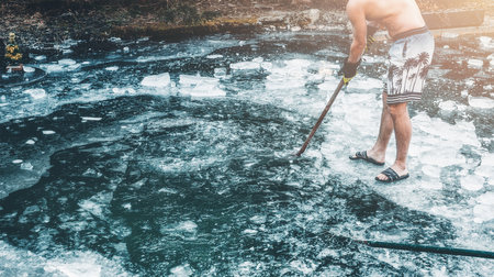 Man getting ready to swim in a frozen lake.の写真素材