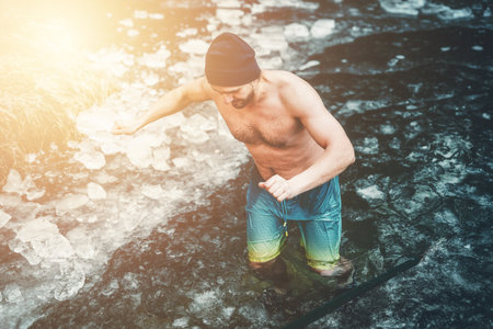 Winter swimming. Man in an ice-hole. winter hardening.の写真素材