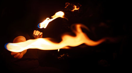 An enchanting fire dancer beautifully showcases her talent with mesmerizing flames during a...
