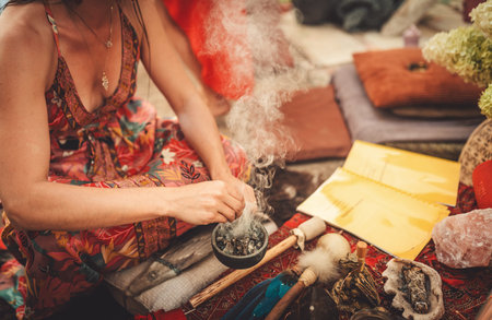 incense in a woman hand, ceremony space.