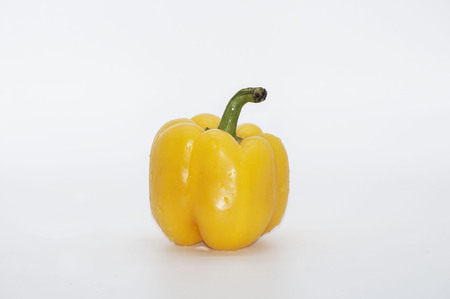 yellow pepper isolated on whiteの写真素材