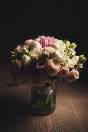 beautiful fresh roses on a table in a glass vaseの写真素材