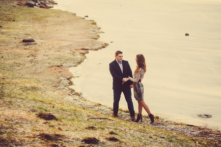 couple walking in the park near the riverの写真素材