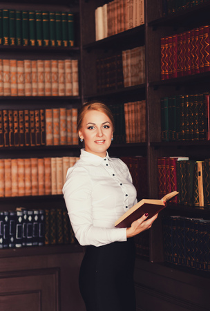 Portrait of a business woman with a book in his officeの写真素材