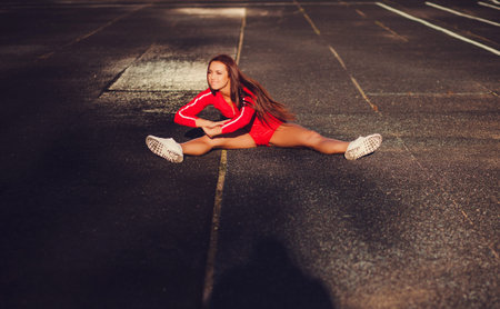 Young female runner doing stretching exercise before began run