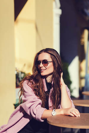 Fashion portrait pretty woman wearing sunglasses and coatの写真素材