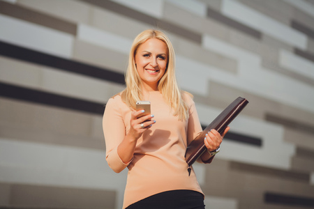 Lawyer businesswoman professional with smart phone looking at camera. Caucasian businesswoman smilingの写真素材
