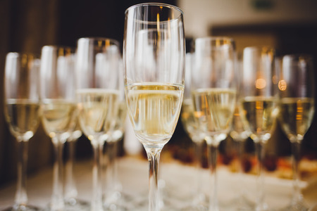 glasses of champagne on on blurred backgroundの写真素材