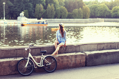 young woman on a bicycle looking away. copy spaceの写真素材