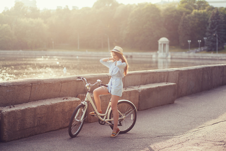 Young beautiful, elegantly dressed woman with bicycle. Fashion and lifestyleの写真素材