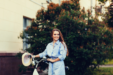beautiful fashion girl with bicycle outdoorの写真素材