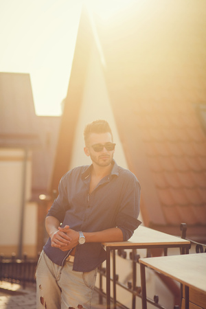 Fashion man on street at sunsetの写真素材