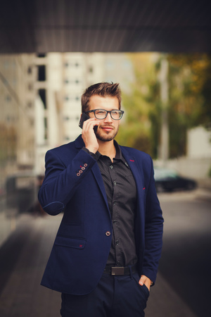 business, technology and people concept - businessman with smartphone talkingの写真素材