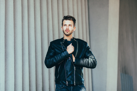 Stylish man in leather clothes posing in the cityの写真素材
