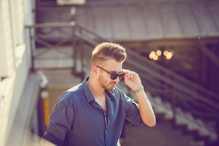 handsome young man in sunglasses outdoorsの写真素材