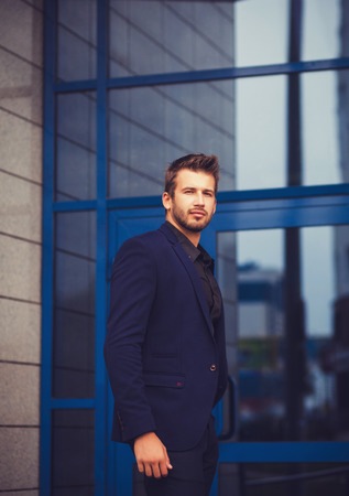 Portrait of a businessman in blue suit near officeの写真素材