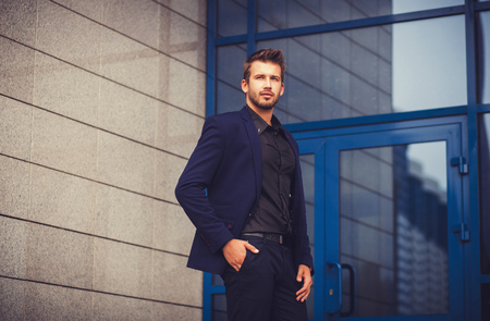 Portrait of a businessman in a blue suit men near the officeの写真素材