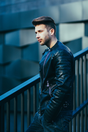 Attractive young male model posing in leather jacket. Fashion photoの写真素材