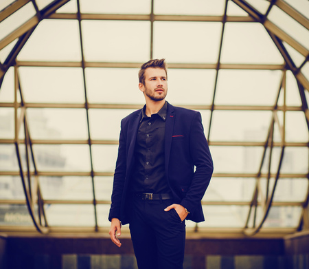 Elegant young handsome man. Outdoors fashion portrait.の写真素材
