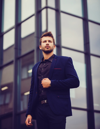 Elegant young handsome business man wearing suit and watches.の写真素材