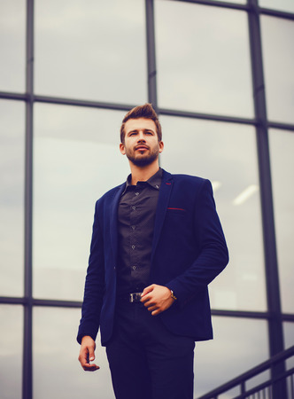 Elegant young handsome man in blue suit and shirtの写真素材