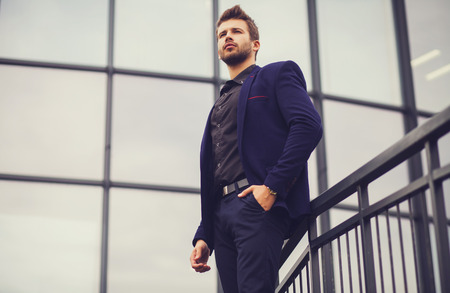 Male businessman on background of office buildingの写真素材