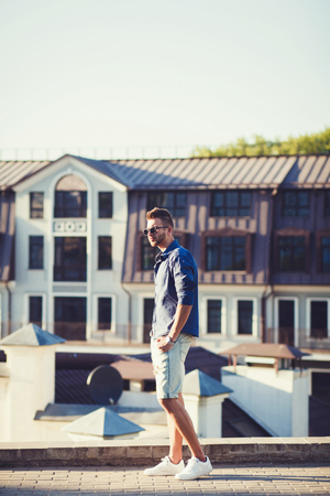 Portrait of a young handsome man, fashion model, in urban backgroundの写真素材