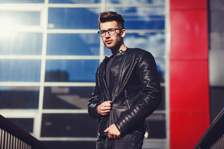Portrait of a handsome man dressed in black leather jacket and jeansの写真素材