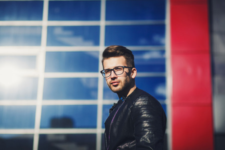 Confident handsome man in glasses and leather jacket. Men's beauty, fashion.の写真素材
