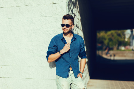 Portrait of a handsome man, fashion model, in urban backgroundの写真素材