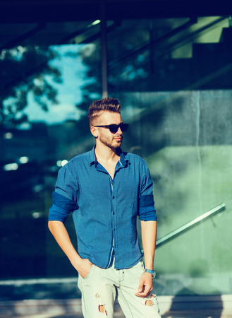Handsome man in blue shirt outdoorの写真素材